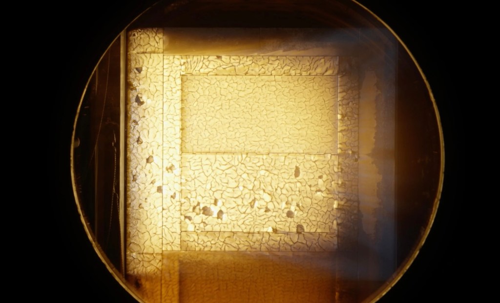 A block of Avcoat undergoes testing inside an arc jet test chamber at NASA Ames.
