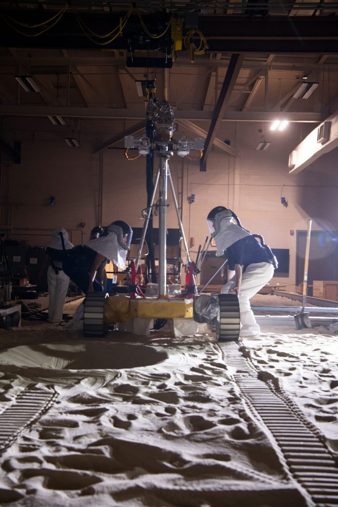 The VIPER Mobility Test Platform preparing to drive through a simulated crater