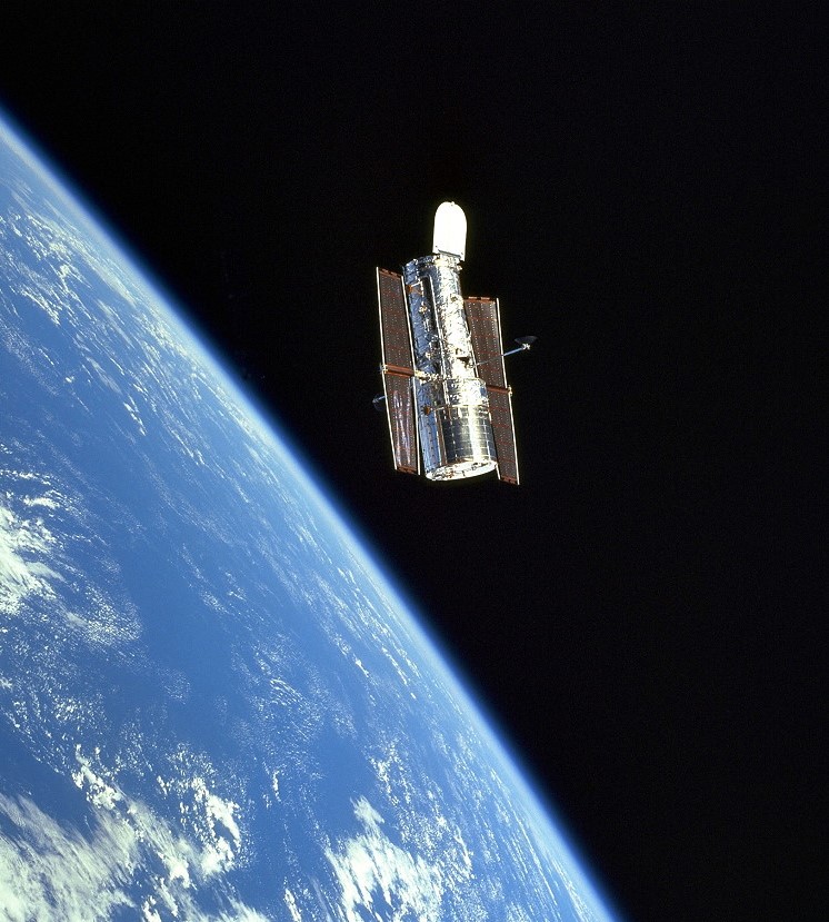 View of the Hubble Space Telescope against the limb of the Earth and black sky