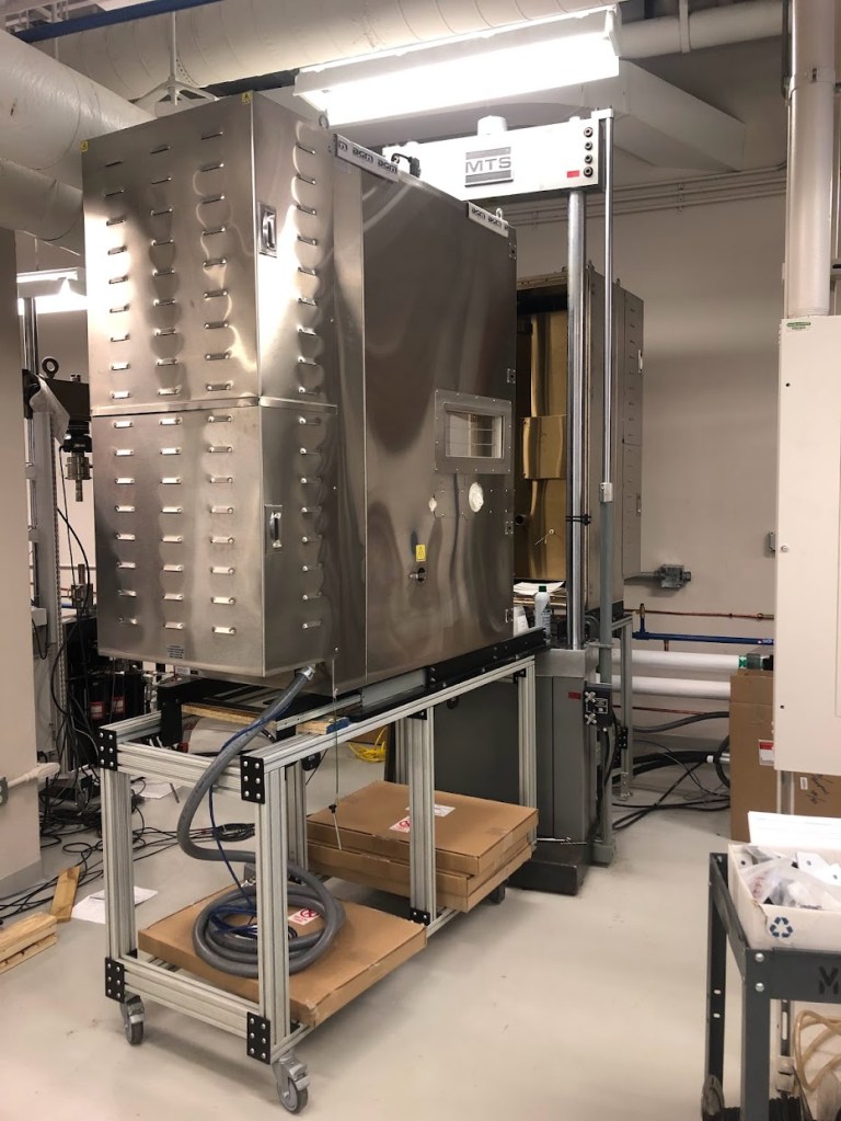 Extreme Cyclic Environmental Load test rig showing both halves of the environmental chamber aligned with the hydraulic load frame