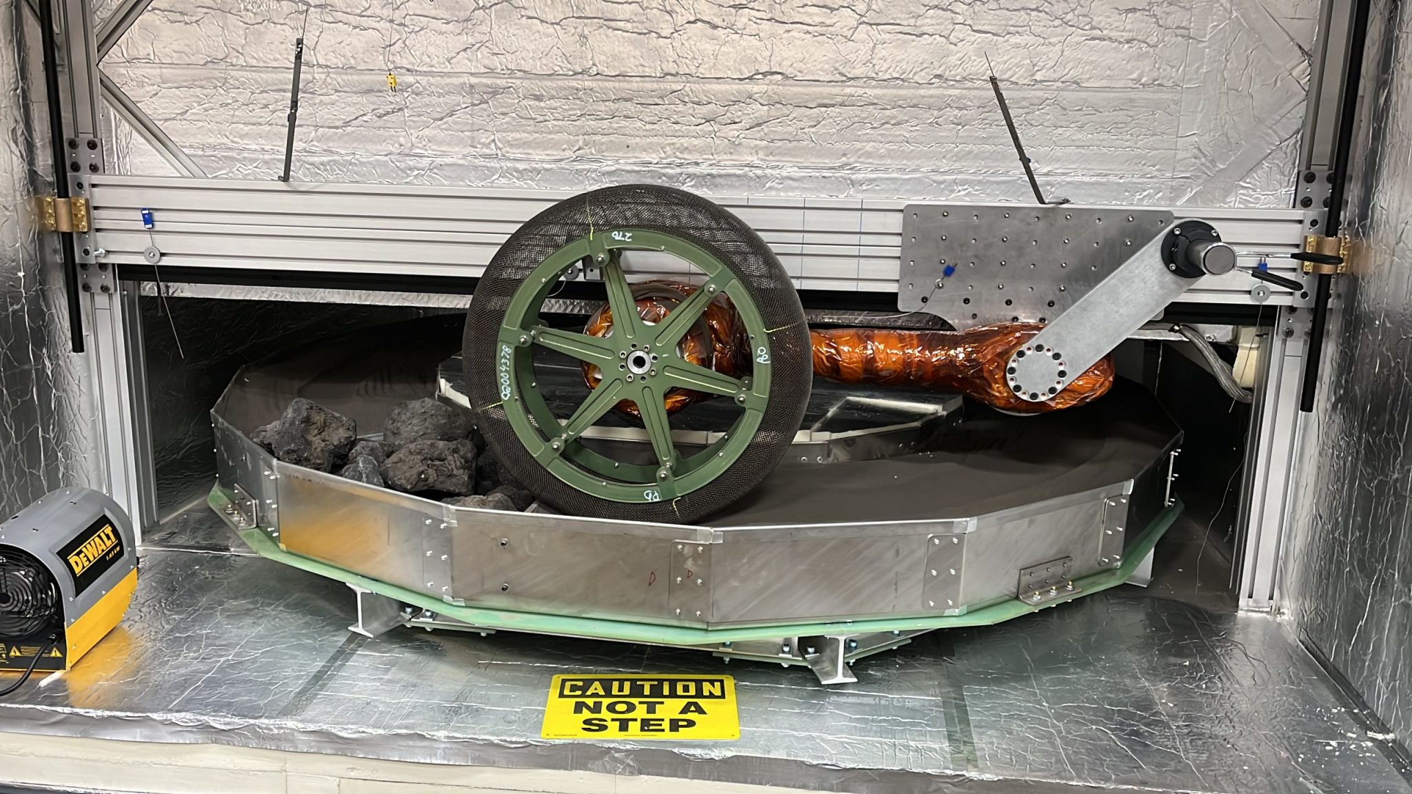 Extreme Terrain Endurance Rig with 70-centimeter-diameter Spring Tire driving on JSC-1a lunar simulant and rocks