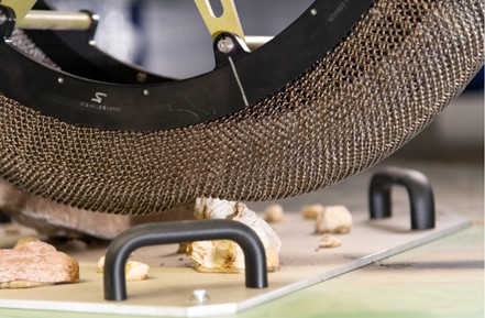 Interaction between a spring tire and terrain element on the Extreme Terrain Endurance Rig test rig