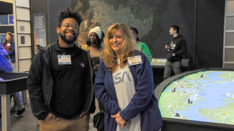 two ACCP volunteers pose for a photo while attending the FIRST Robotics Kickoff event