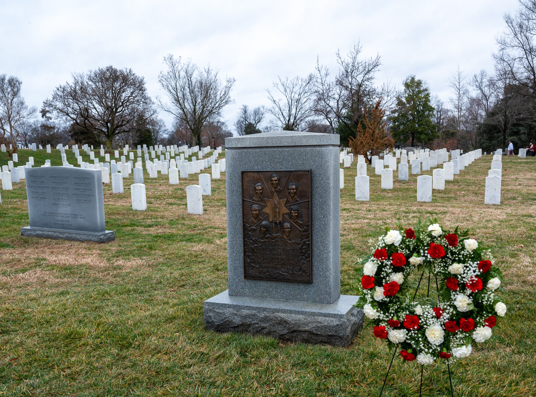 A wreath is seen by the Space Shuttle Challenger Memorial during a wreath laying ceremony that was part of NASA's Day of Remembrance, Thursday, Jan. 25, 2024, at Arlington National Cemetery in Arlington, Va. The wreaths were laid in memory of those men and women who lost their lives in the quest for space exploration.