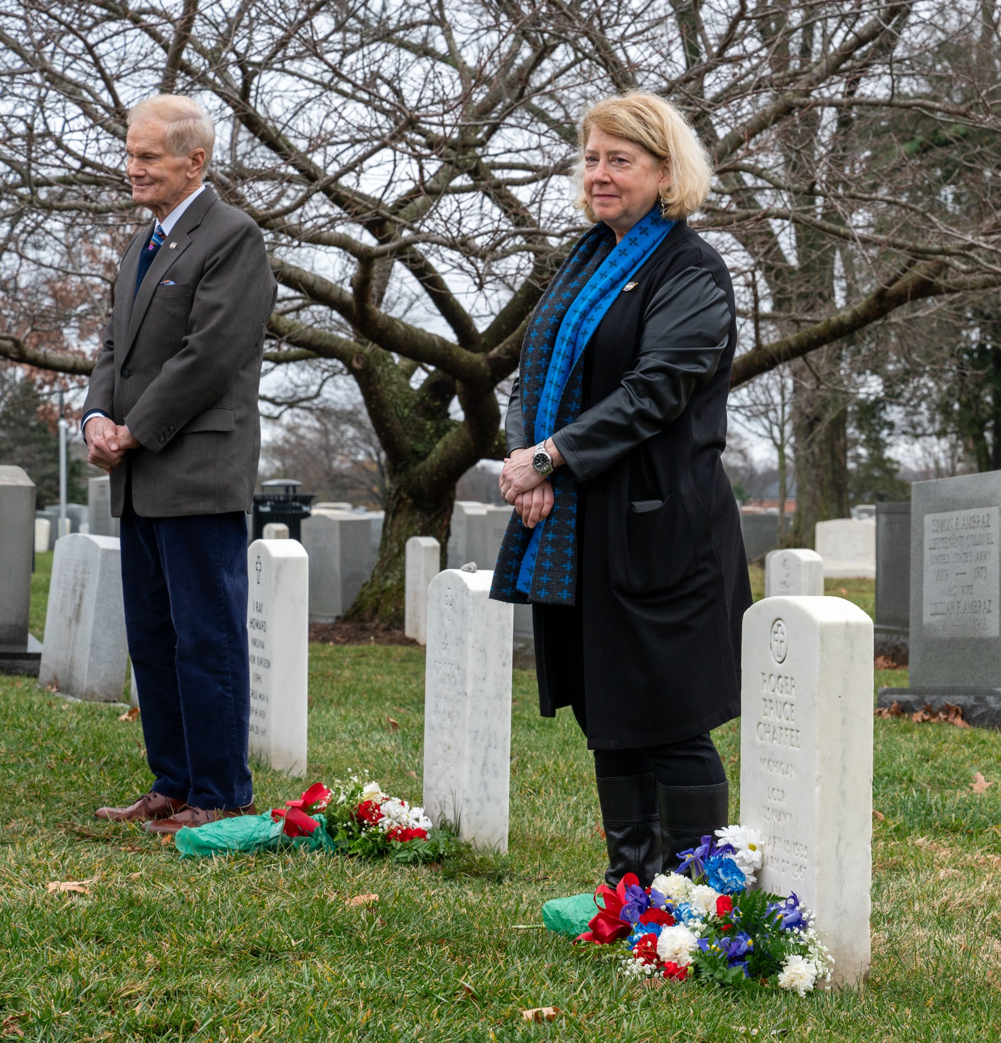 NASA Administrator Bill Nelson and NASA Deputy Administrator Pam Melroy place flowers at the grave markers of Virgil "Gus" Grissom and Roger Chaffee from Apollo 1, during a ceremony that was part of NASA's Day of Remembrance, Thursday, Jan. 25, 2024, at Arlington National Cemetery in Arlington, Va. The wreaths were laid in memory of those men and women who lost their lives in the quest for space exploration.