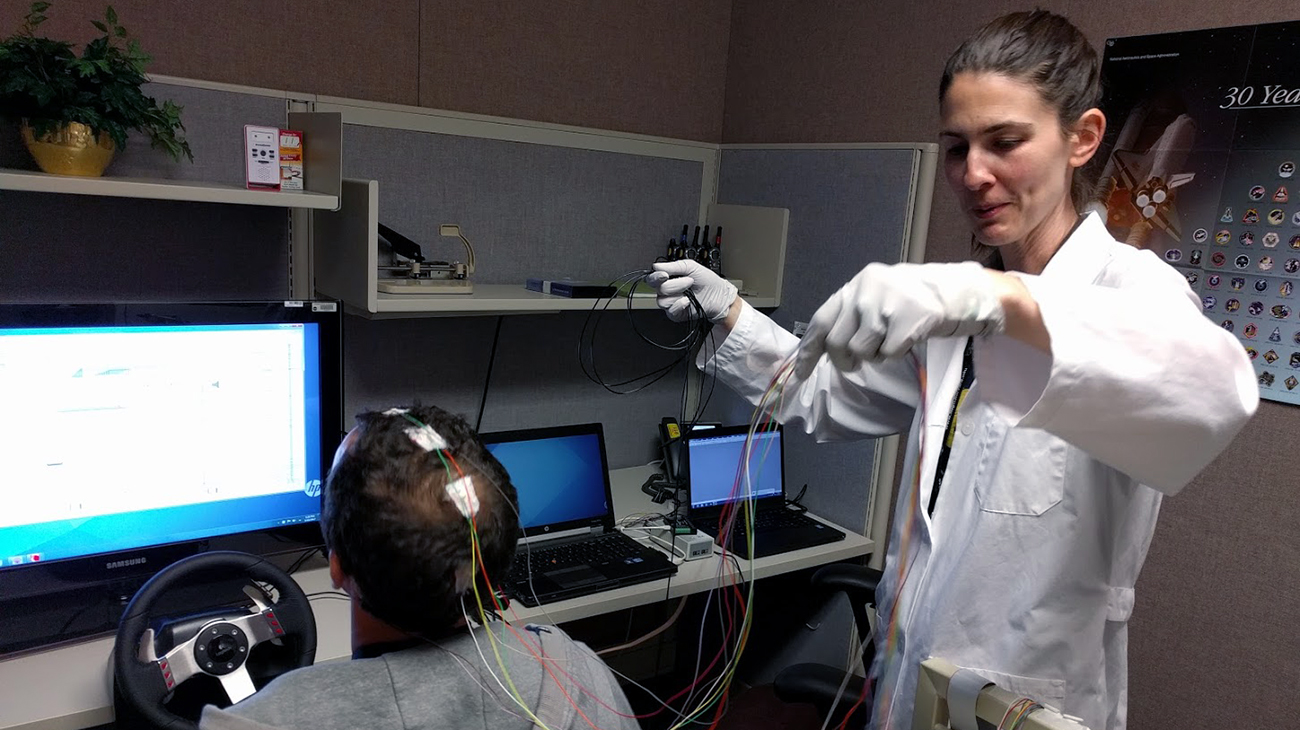 NASA researcher Dr. Erin Flynn-Evans, lead of NASA's Fatigue Countermeasures Group, prepares a research subject for a fatigue study.