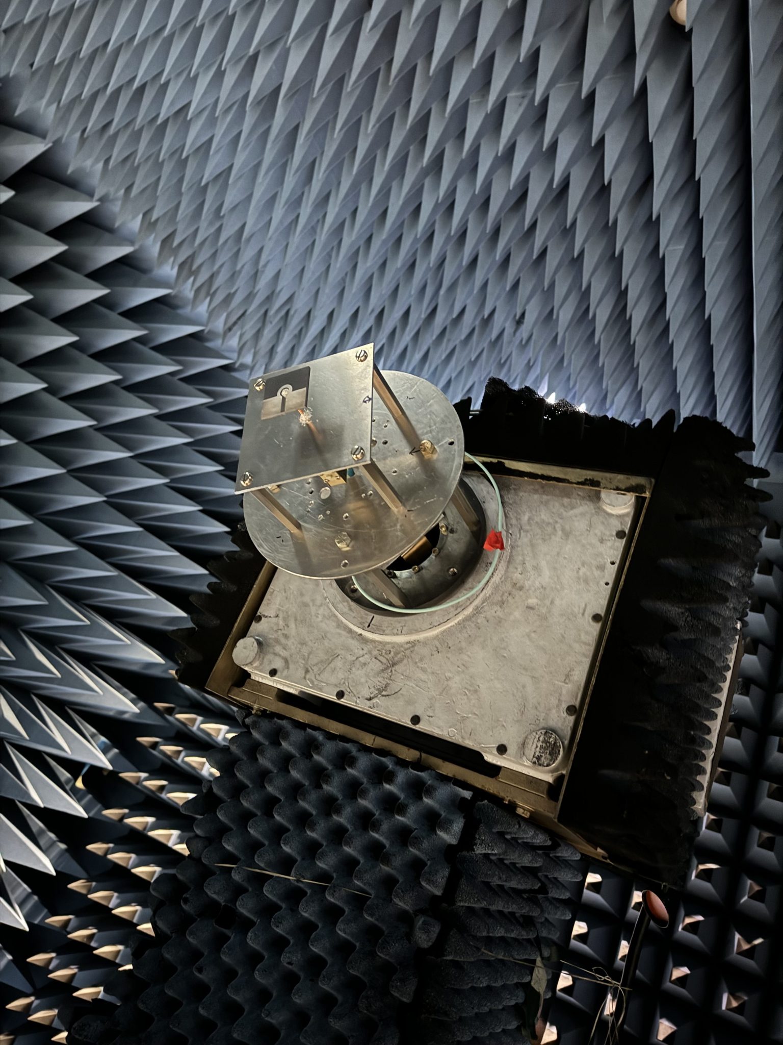 NASA Goddard’s anechoic chamber eliminates echoes and reflections of electromagnetic waves to simulate the relative “quiet” of space. Here, the antenna is installed on the mast of the anechoic chamber.