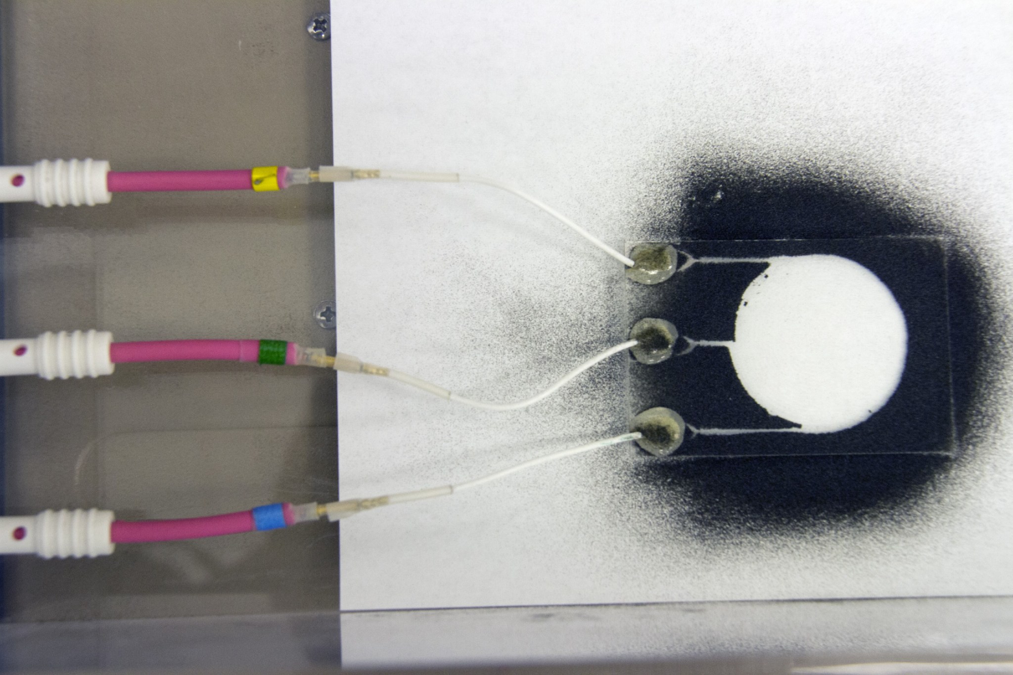 Dust particles scatter during an experiment for the Electrodynamic Dust Shield for Dust Mitigation.