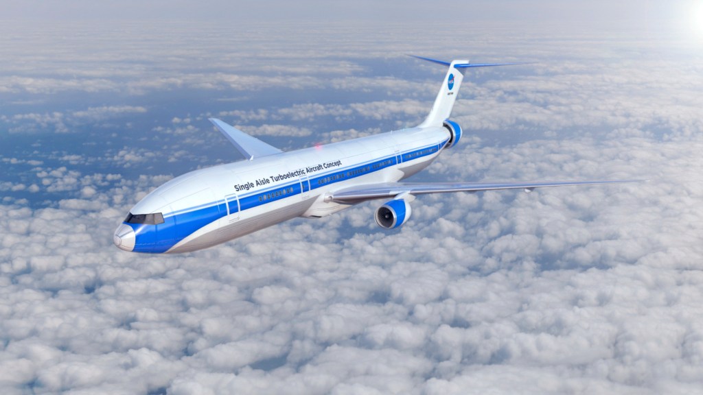 A single-aisle aircraft with a rear motor flies across a blue sky with clouds in the background.