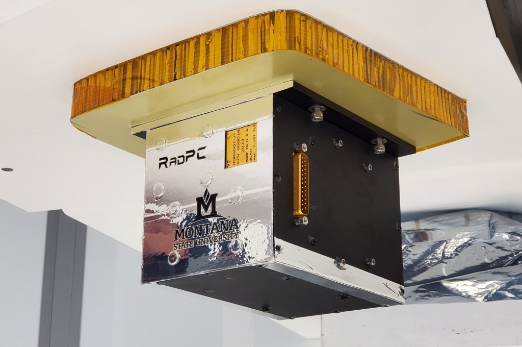 A silver cube with the name RadPC is attached to a golden square.
