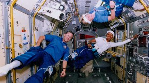 NASA astronauts (left to right) Jerome Apt, Jan Davis, and Mae Jemison in the Space Shuttle Endeavour during the STS-47/Spacelab J mission. Mae Jamison is wearing the Autogenic Feedback Training (AFTE) suit, developed by NASA researcher Dr. Pat Cowings.