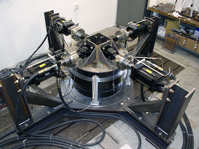 A jet engine fan case being subjected to a four-axis structural test in the Structural Static Laboratory.