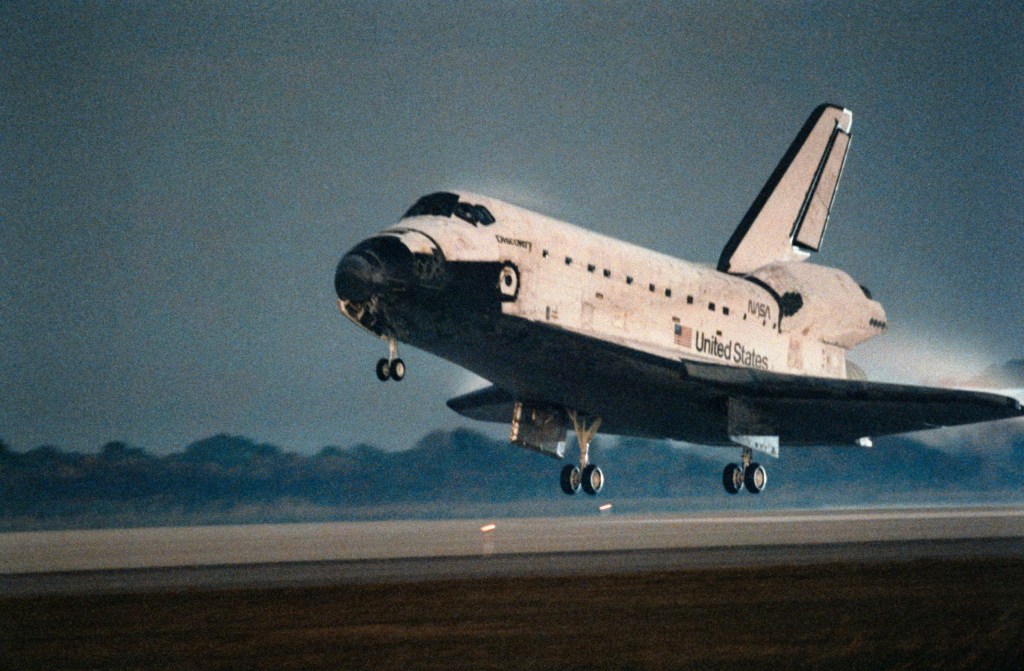 Image of a space shuttle touching down after its mission.