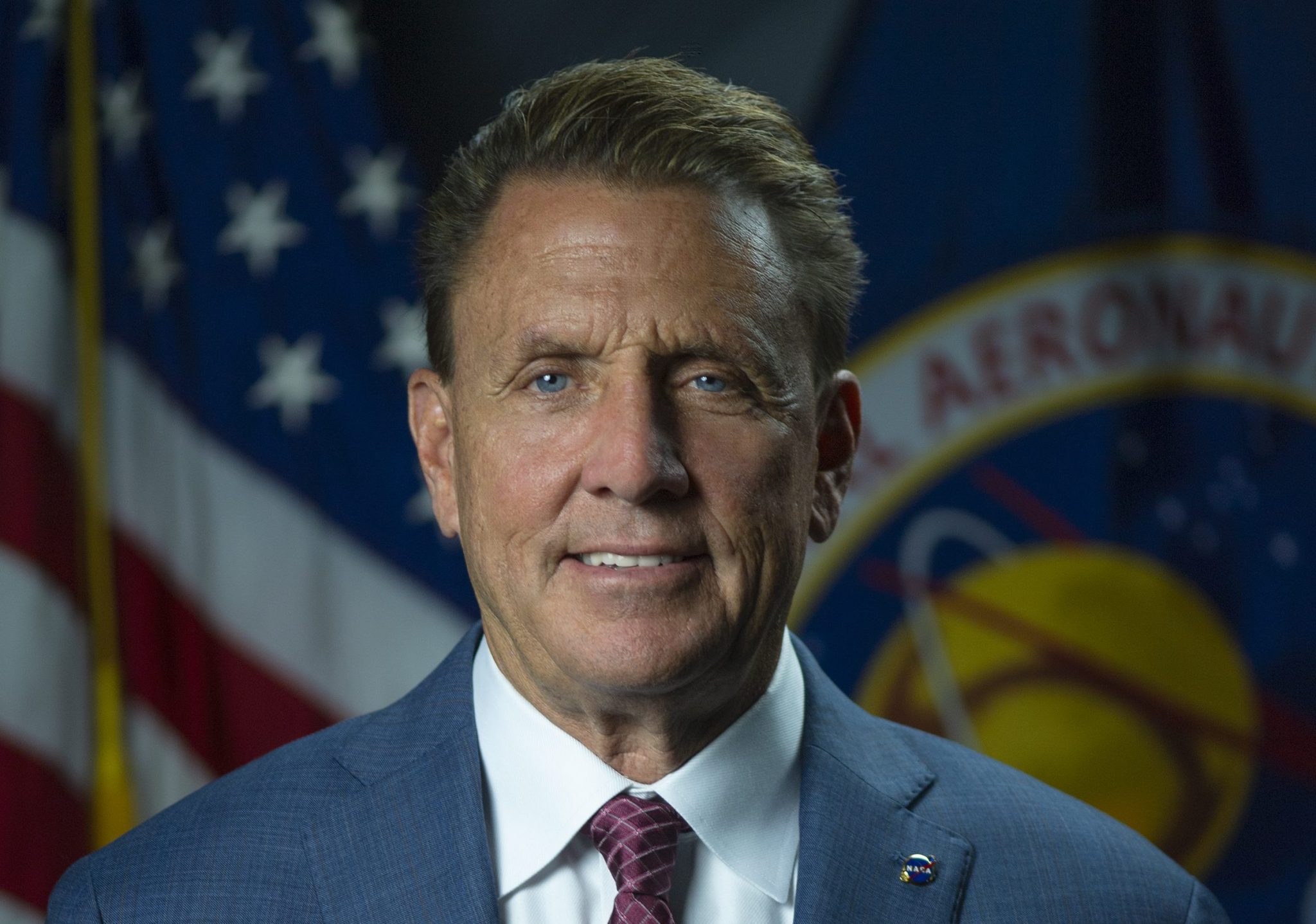 Tim Pierce sits for an official NASA portrait