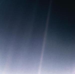Earth is a single, bright blue pixel in the vastness of space. Rays of sunlight scattered within the camera optics stretch across the scene, one of which happens to have intersected dramatically with Earth. The original image was taken on Feb. 14, 1990. What you see here is an updated version from 2020 using modern image-processing software and techniques.⁣⁣