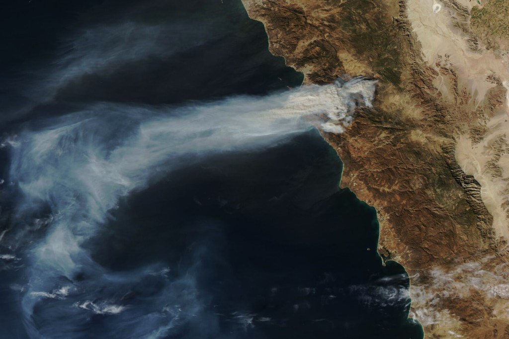 Hot, dry weather and strong winds fueled wildland fires in Baja California in late January 2025. Seasonal Santa Ana winds blew in from dry areas inland and accelerated down the Sierra Juarez mountain range, creating conditions where a few sparks and small brush fires could quickly escalate. The MODIS (Moderate Resolution Imaging Spectroradiometer) on NASA’s Aqua satellite captured this image of smoke streaming from a large fire in the El Escondido area of Ensenada on January 23, 2025. The image was captured at 1:44 p.m. Pacific Time (21:44 Universal Time).