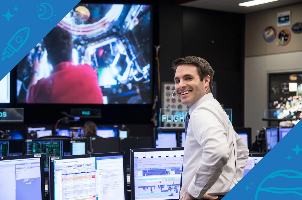 Anthony Vareha, NASA flight director, stands at his desk in Mission Control