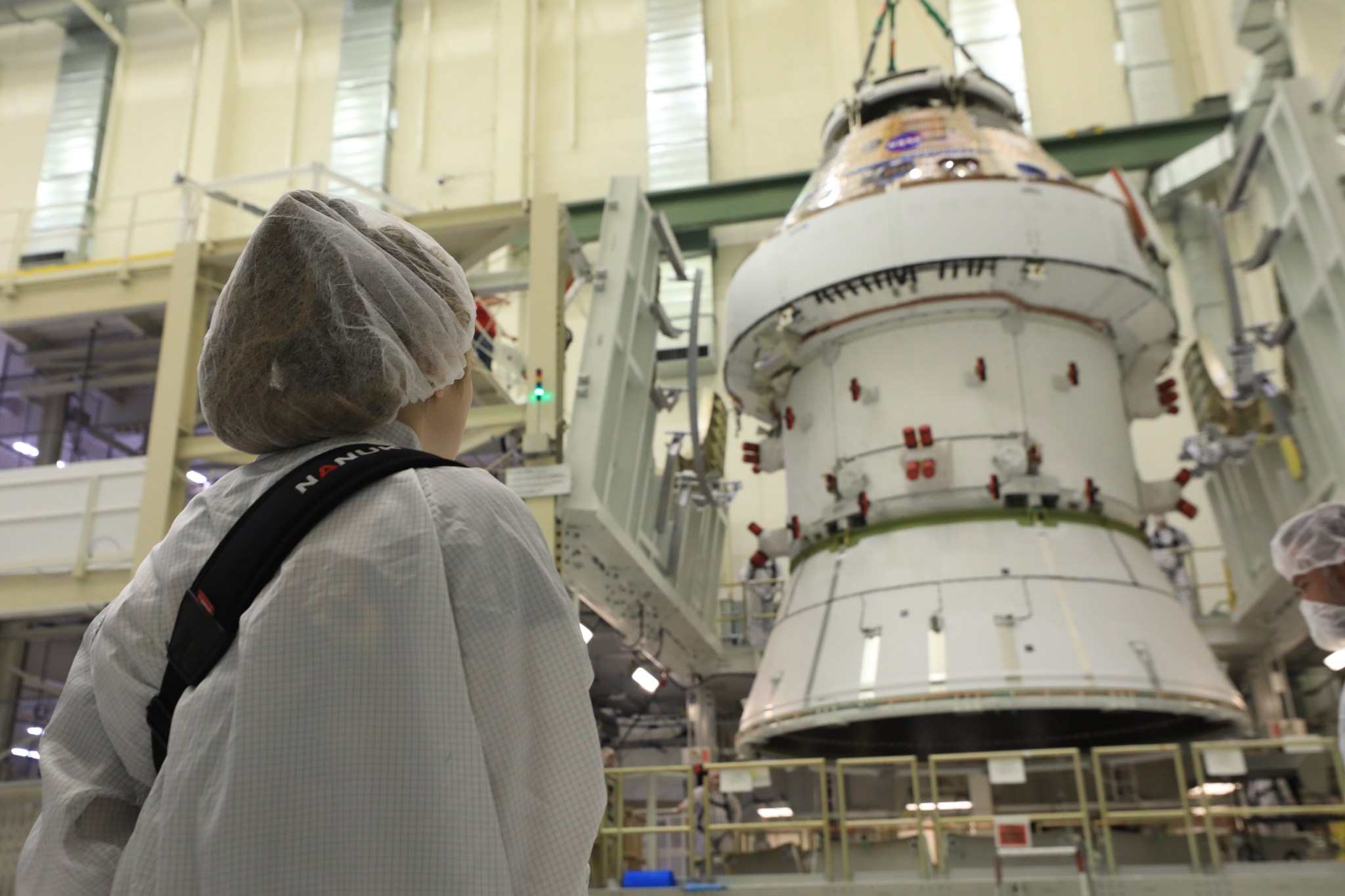 Image shows woman looking at NASA's Artemis II Orion spacecraft