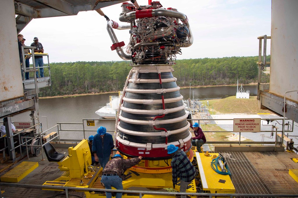 crew installing the first new production RS-25 engine on the Fred Haise Test Stand