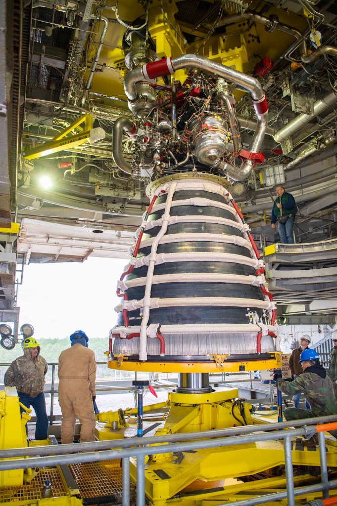 crew installing the first new production RS-25 engine on the Fred Haise Test Stand