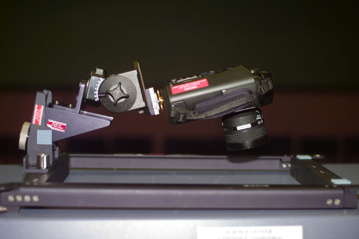 Image of an electronic still camera mounted on space shuttle window.