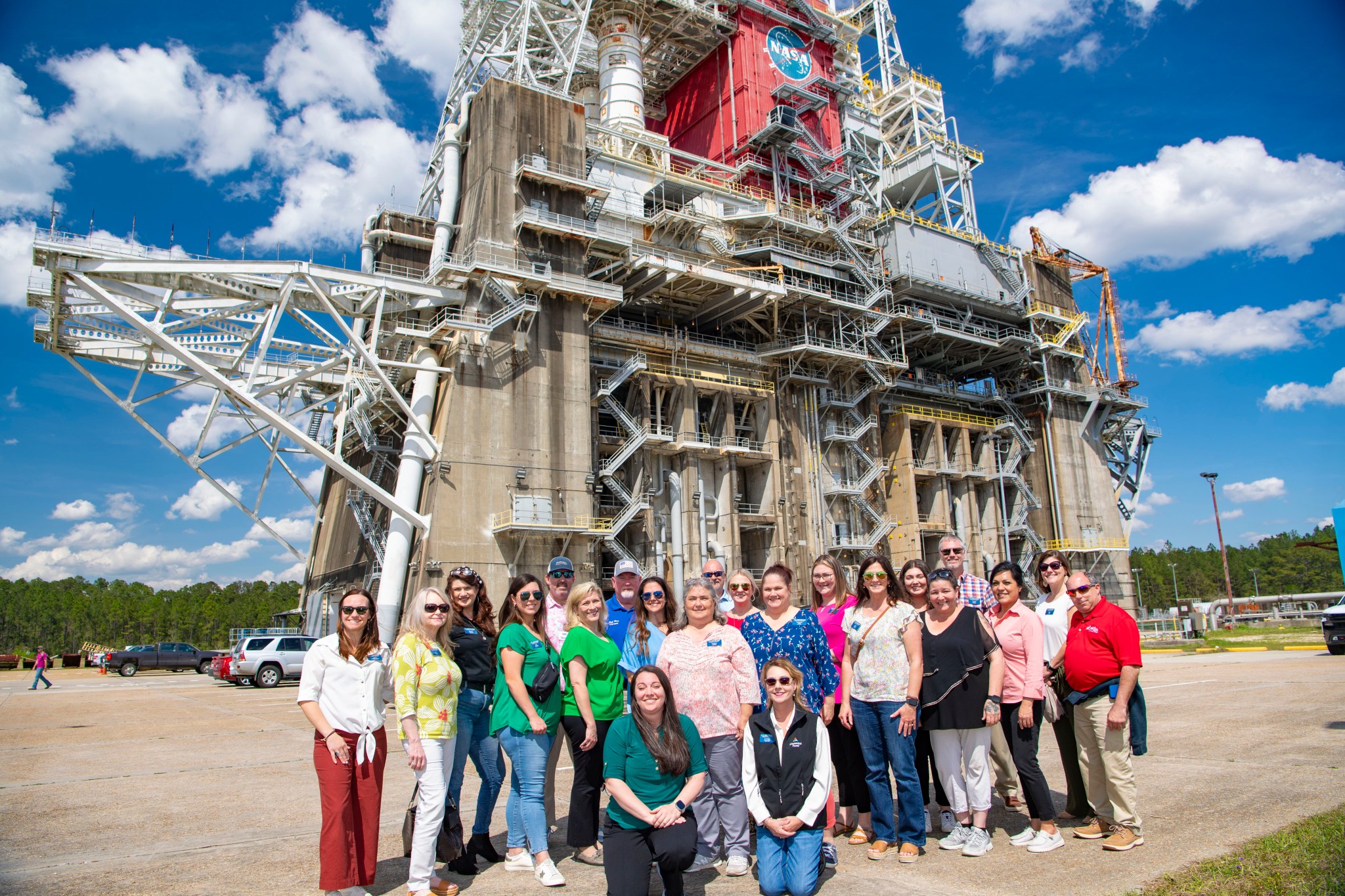 Approximately 50 members of the Leadership Hancock Class of 2025 visit NASA Stennis on March 26 for a full-day tour that included meeting NASA Stennis leaders and seeing center facilities, such as the Thad Cochran Test Stand pictured in the background.