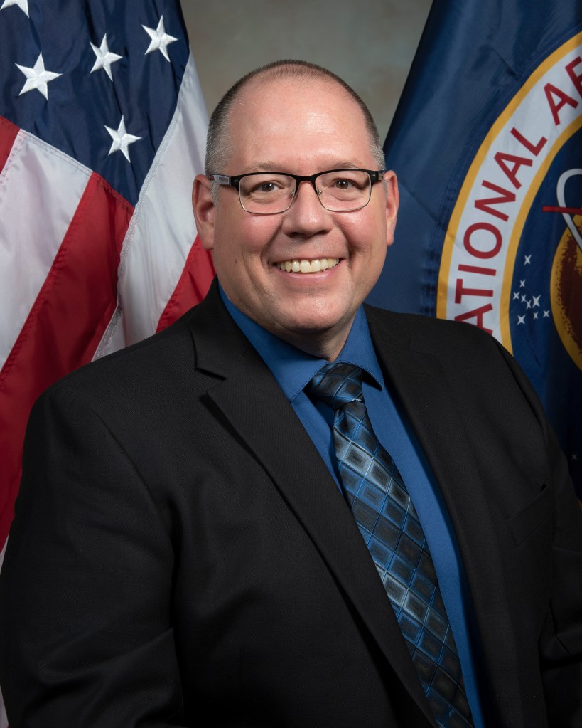 Randy Thompson portrait with flags