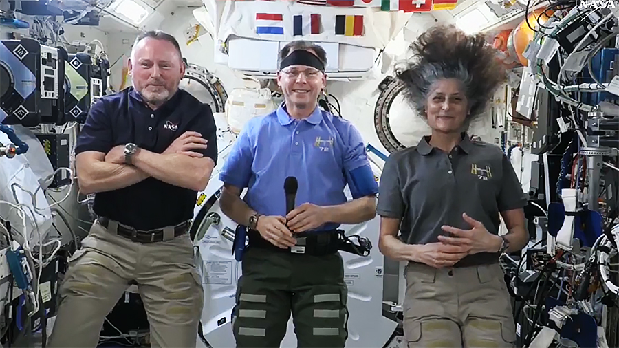 NASA astronauts (from left) Butch Wilmore, Nick Hague, and Suni Williams talk to journalists on the ground during their Pre-Departure News Conference on March 4, 2025.