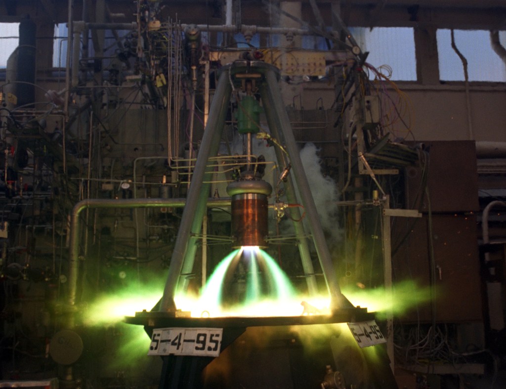Rocket engine firing in test stand.