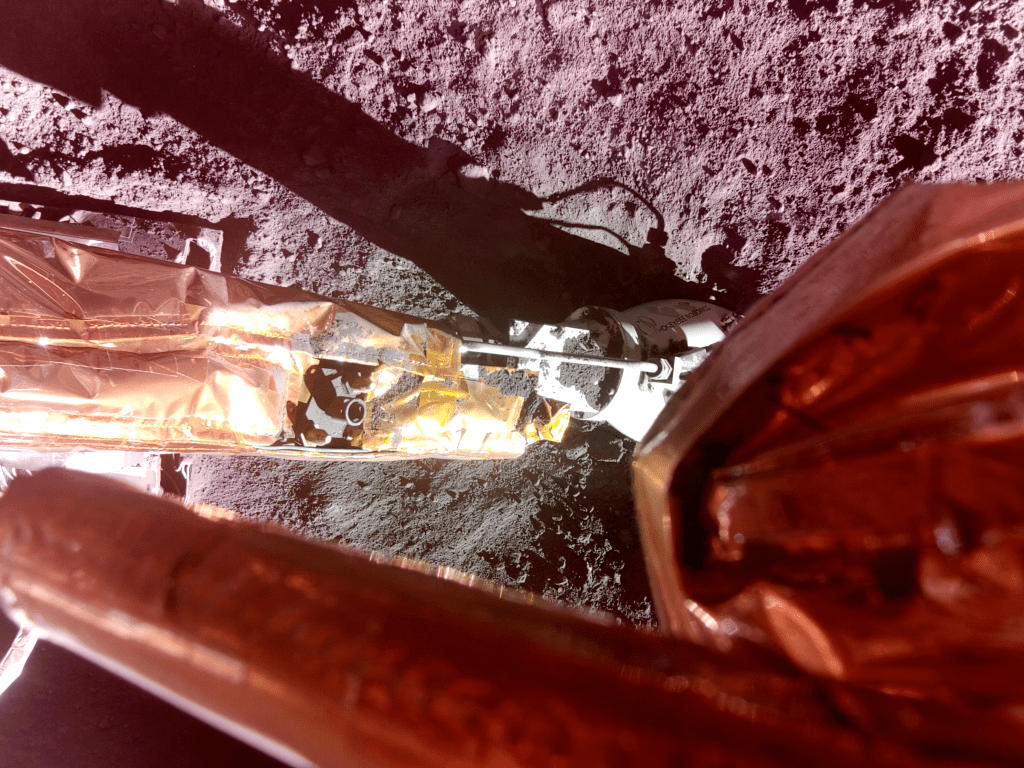Image of Blue Ghost’s Surface Access Arm which deployed NASA's Lunar PlanetVac instrument which is shown on the lunar surface.