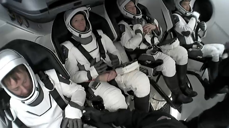 Image shows four astronauts inside SpaceX Dragon spacecraft