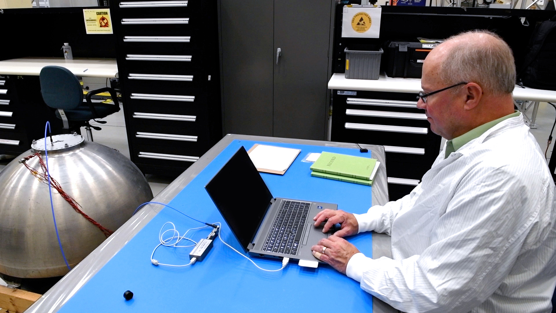 Greg Zimmerli works at a computer that is connected to the RFMG technology.