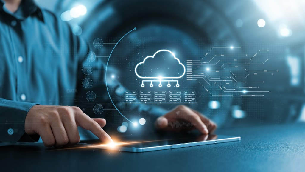 Man touching a tablet and digital information showing up concept showing cloud-based services.