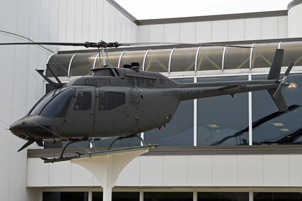 Helicopter mounted in front of building.
