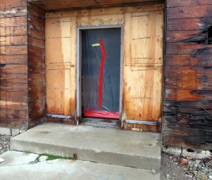 Boarded up doorway.