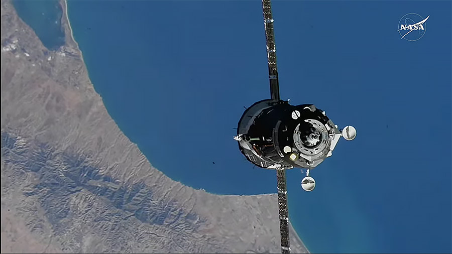 The Soyuz MS-27 spacecraft approaches the International Space Station while orbiting above the Mediterranean coast of Africa.