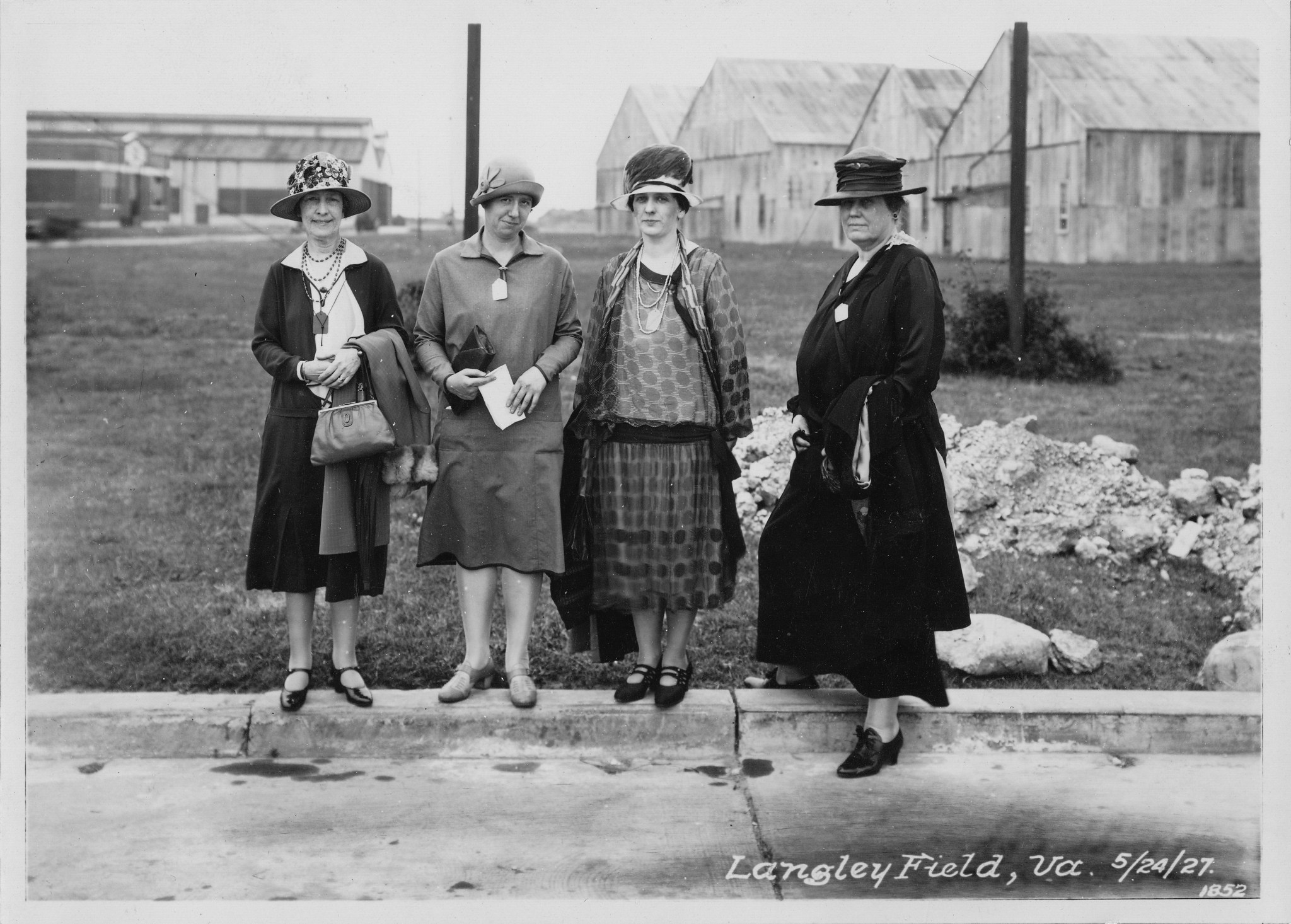 Four women pose on the curb at Langley Field