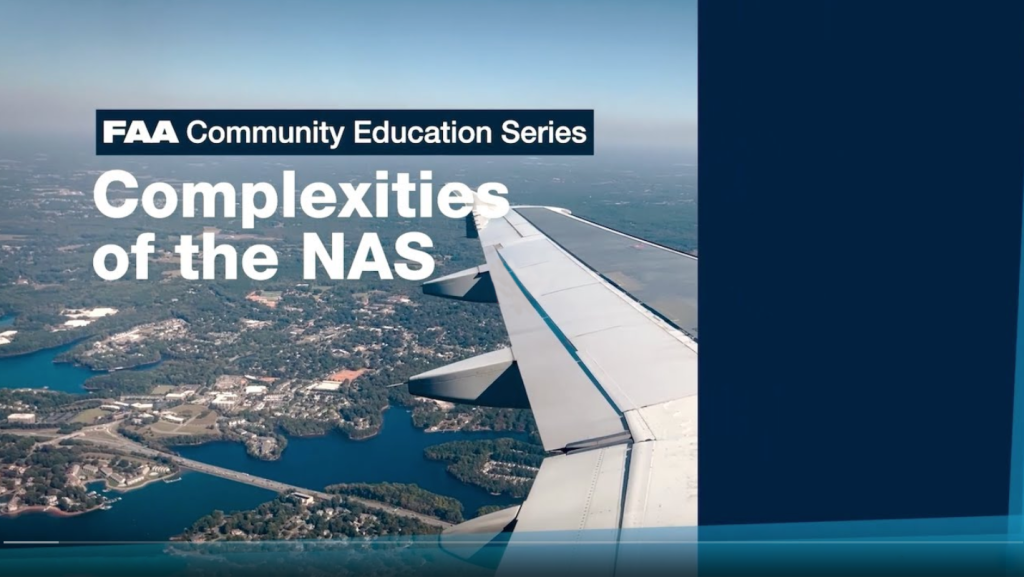 Complexities of the NASA screen shot of the video showing the wing of an airplane in flight over land.