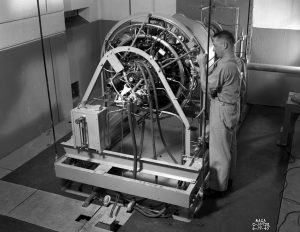 Mechanic working on engine in test cell.