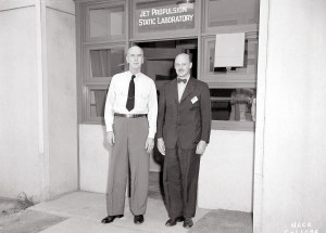 Two men standing outside doorway.