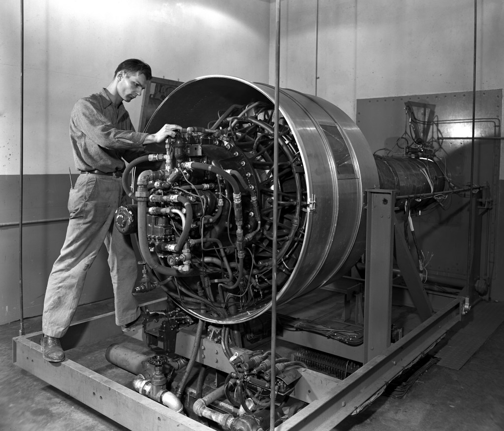Man working on engine in test cell.