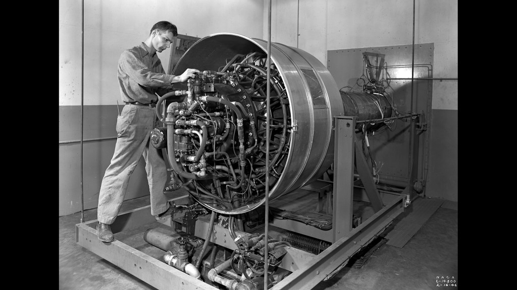 Man working on engine in test cell.