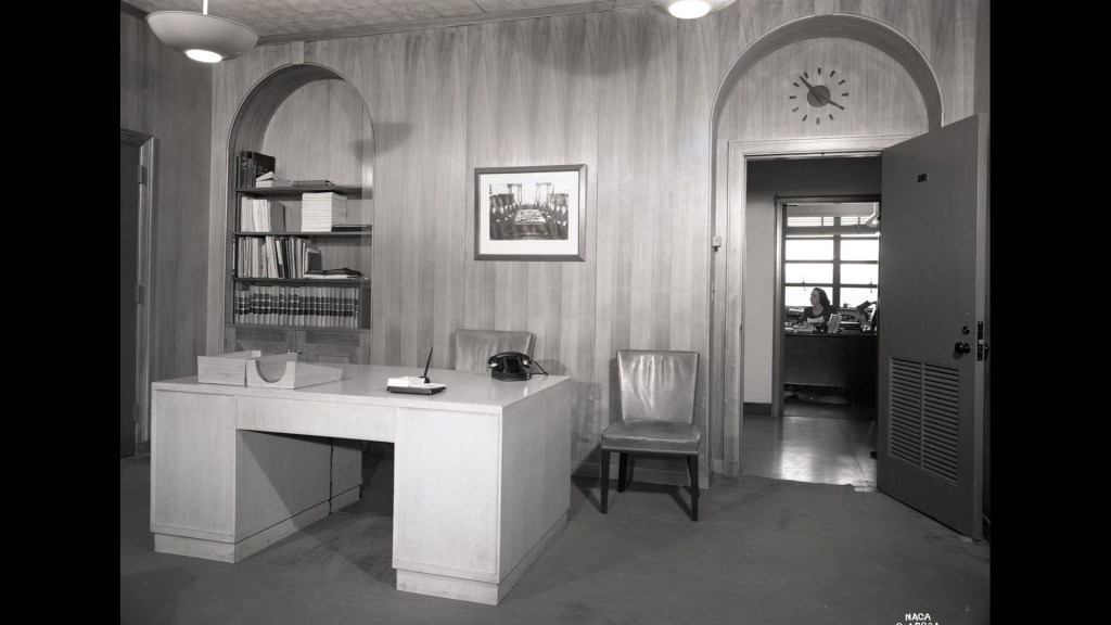 Paneled office with desk.