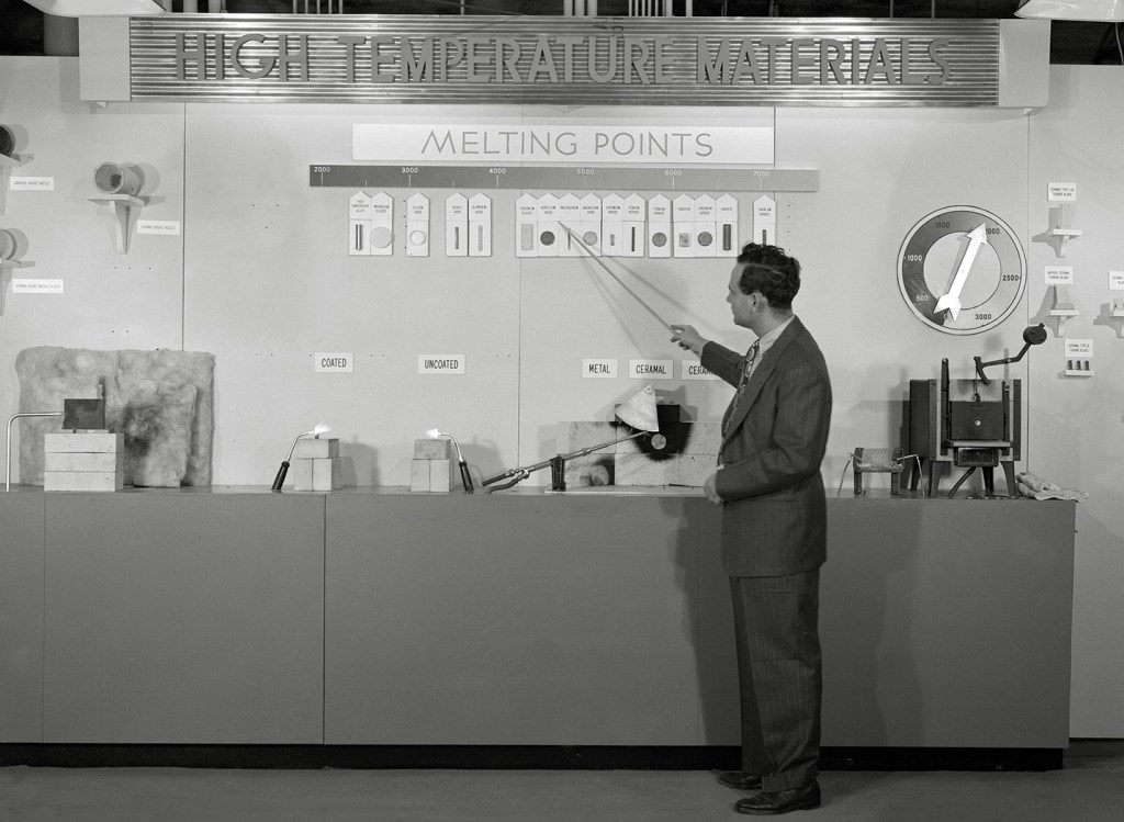 Man with materials research exhibit.