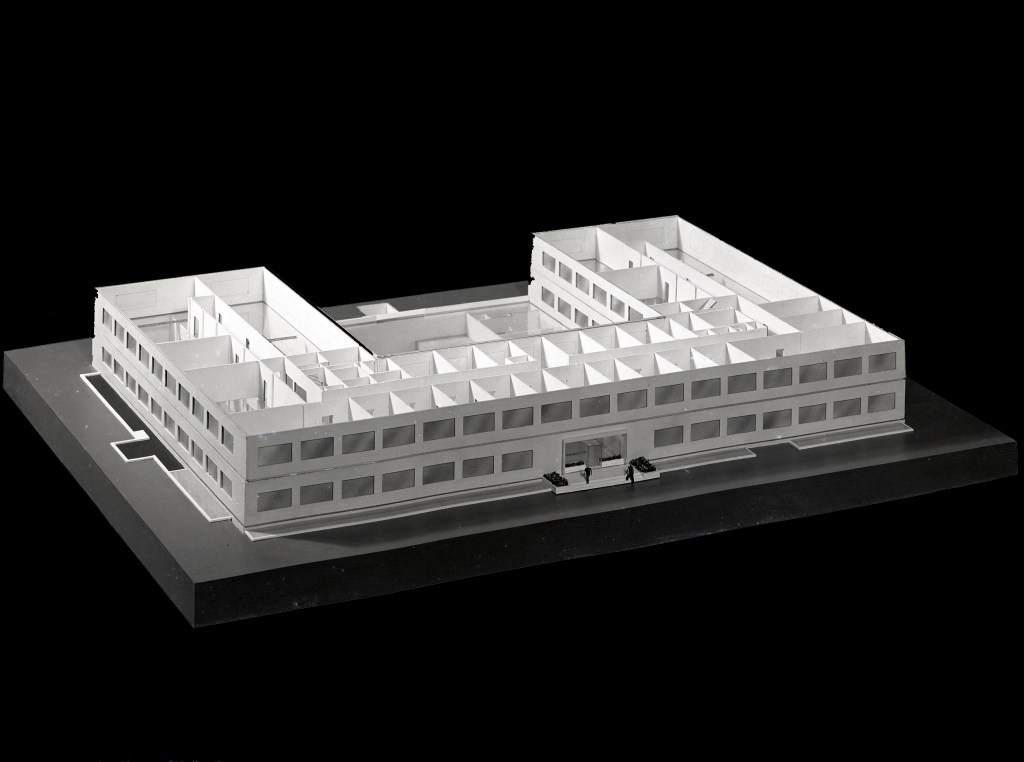 Model of two story U-shaped building.