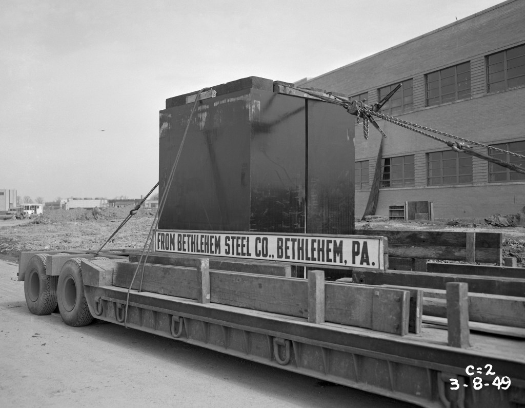 Box strapped to Flatbed truck.