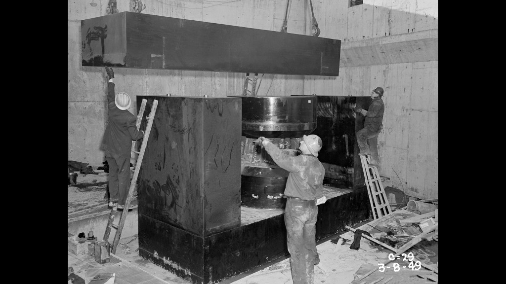 Crane lowering yoke into pit.