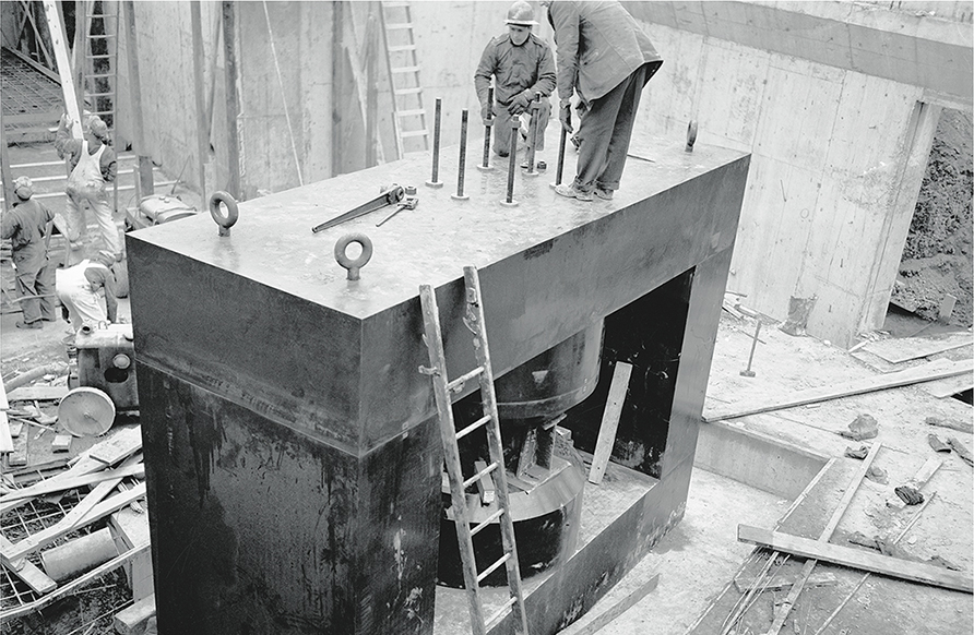 Two men on a large yoke in construction zone.