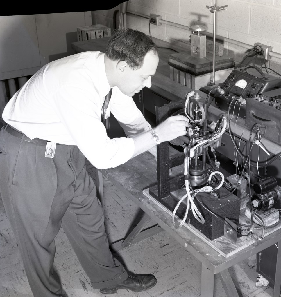 Man working on test equipment.