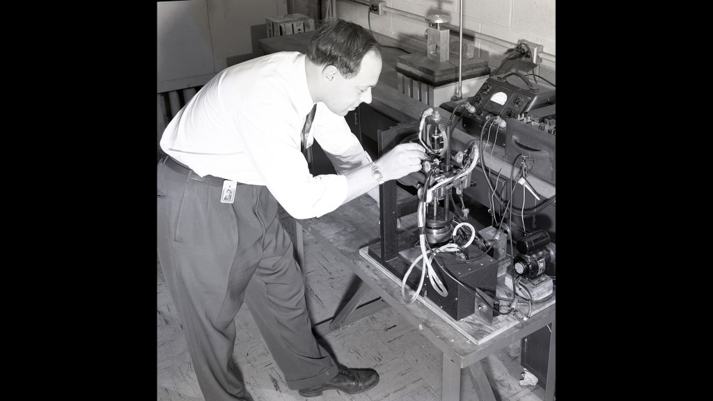 Man working on test equipment.
